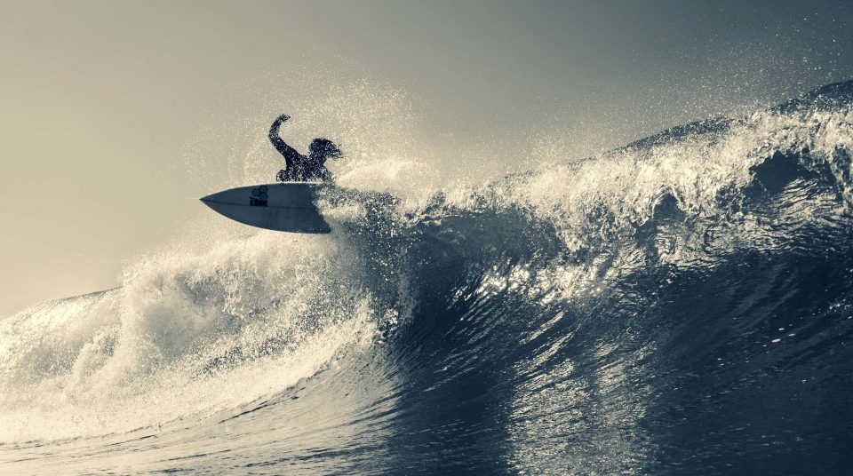 surfer on a beautiful wave while shooting with canon lens